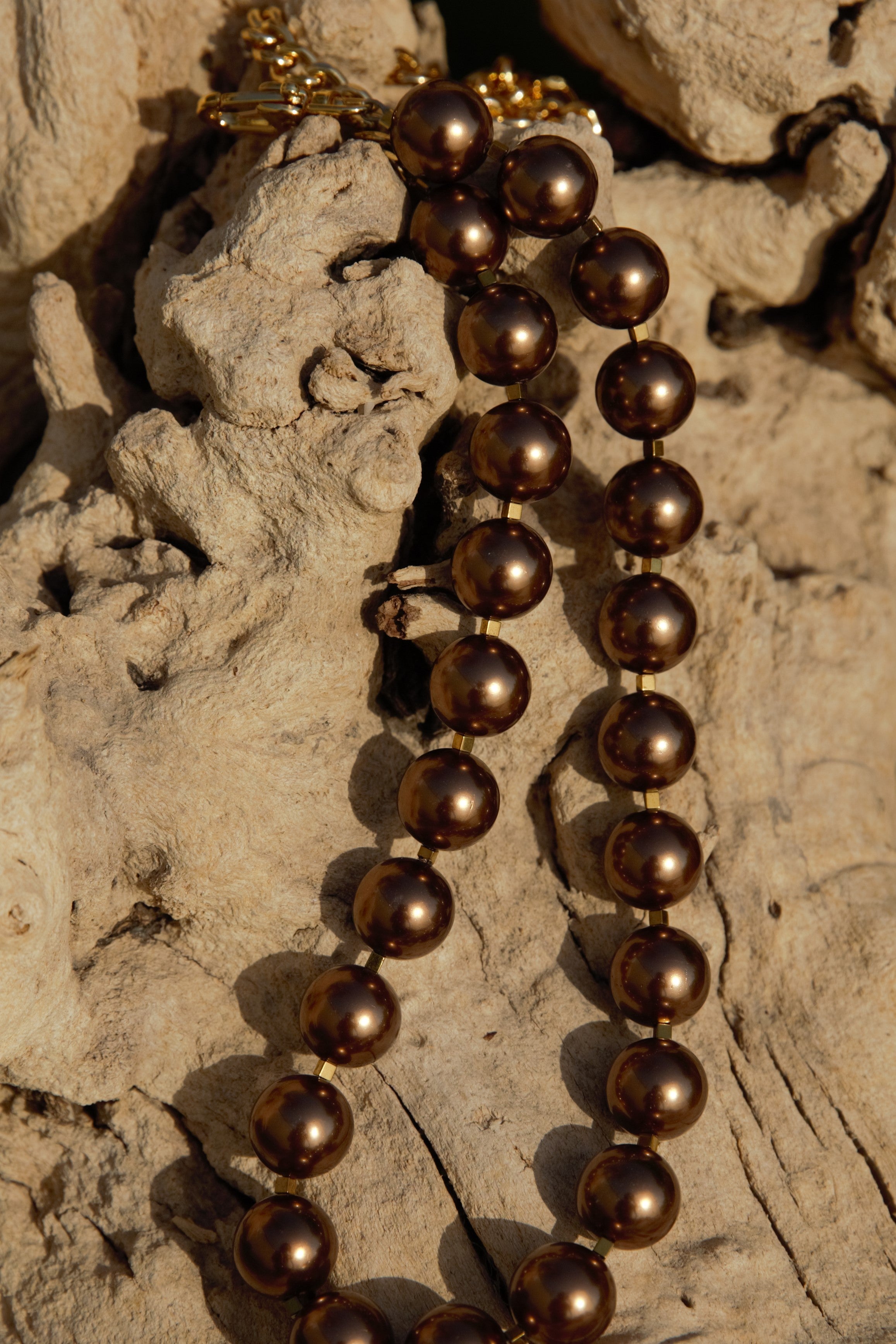 Bronze pearl with gold clasps