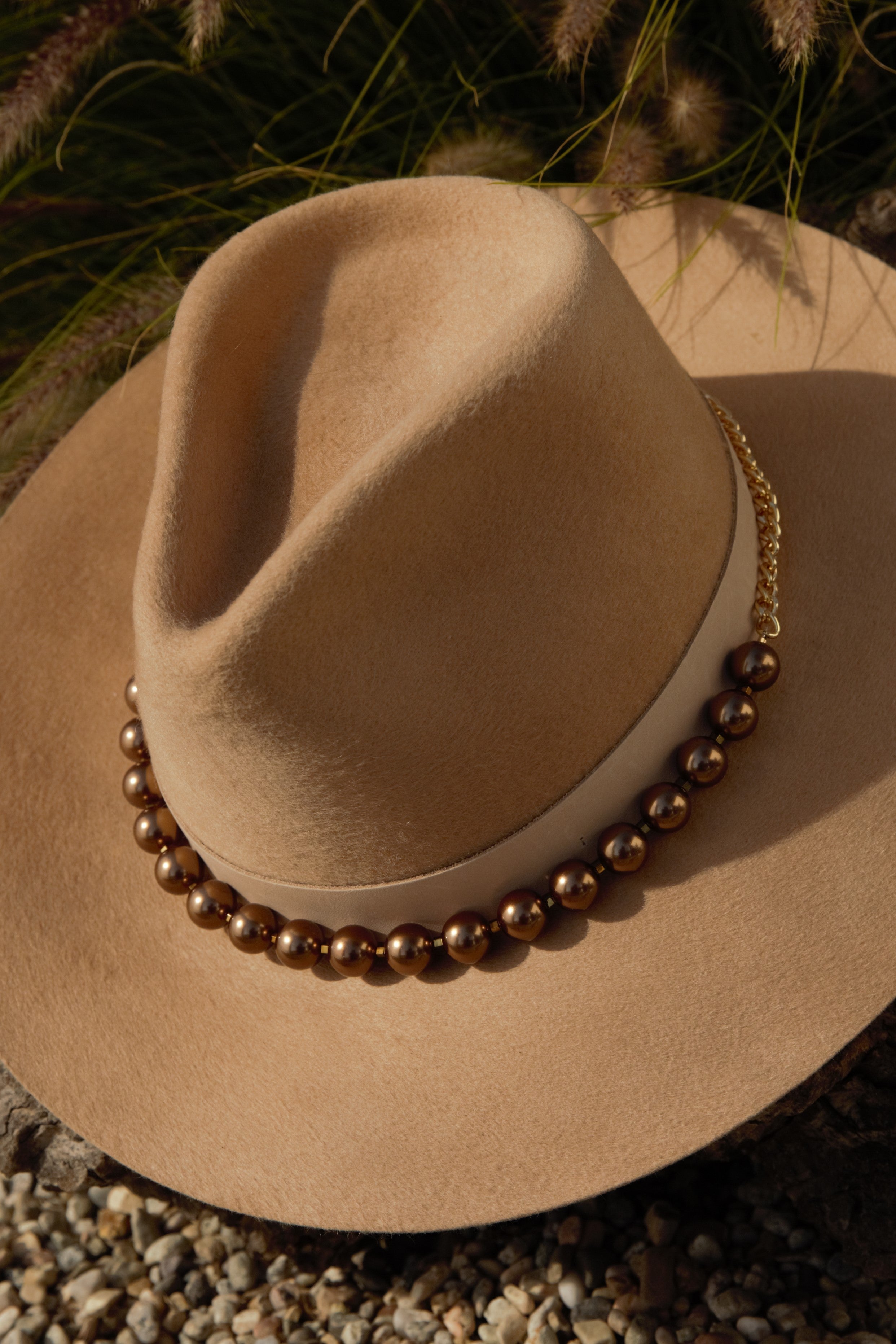 Felt hat featuring the bronze pearl hat band with brass chain 