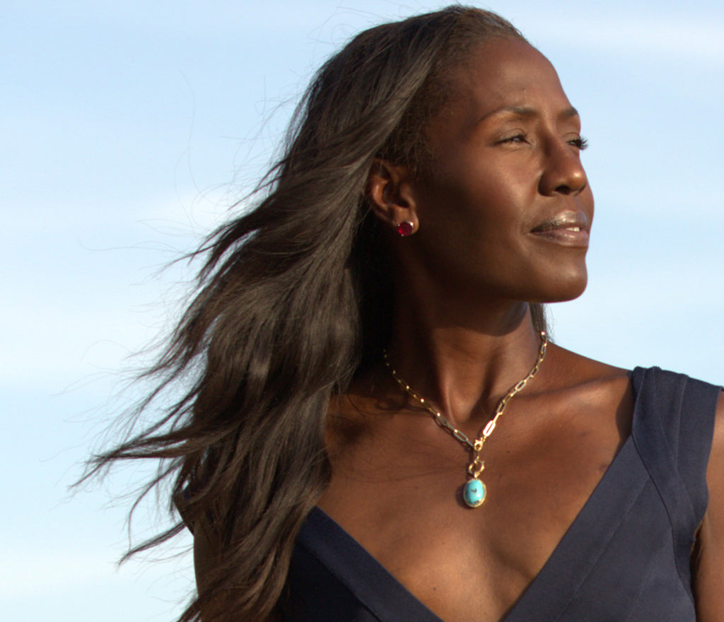 Southern California woman looking off into the distance while wearing a turquoise necklace from Jeuje Fine Jewelry