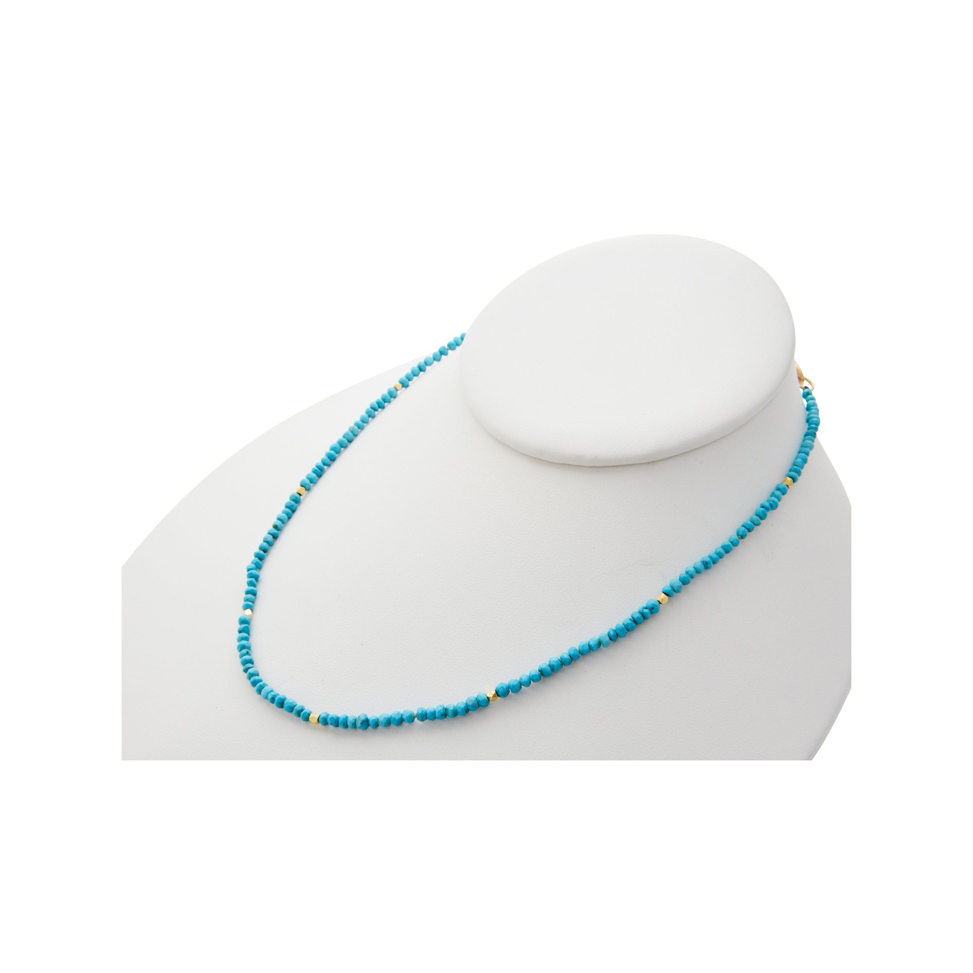 raw turquoise beads with gold accents from Jeuje Fine Jewelry on a white background