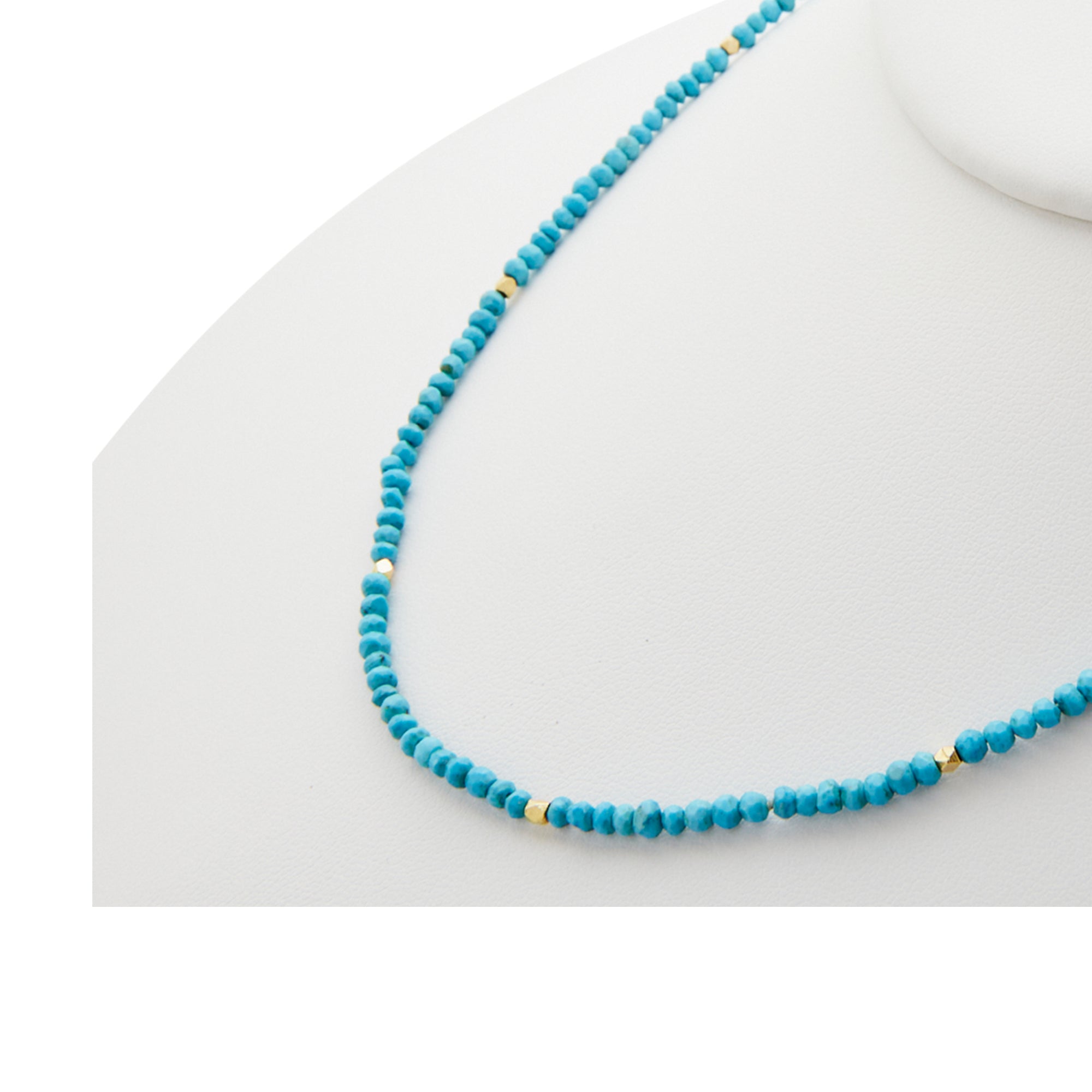 raw turquoise beads with gold accents from Jeuje Fine Jewelry on a white background