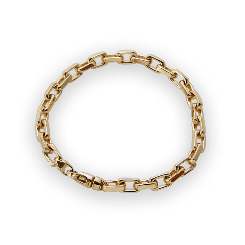 Solid gold heavy link bracelet from Jeuje Fine Jewelry on a white background