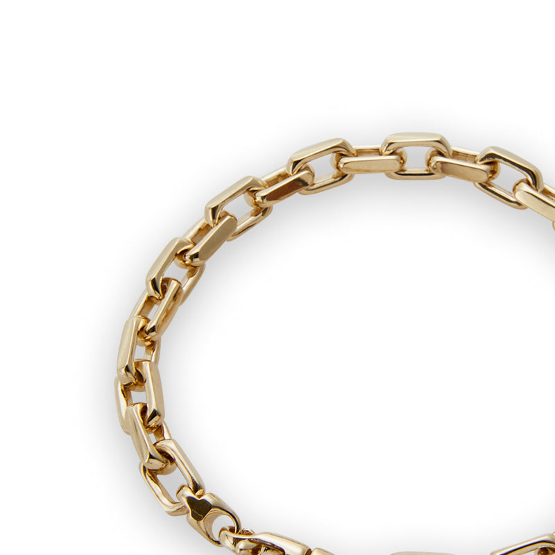 Solid gold heavy link bracelet from Jeuje Fine Jewelry on a white background