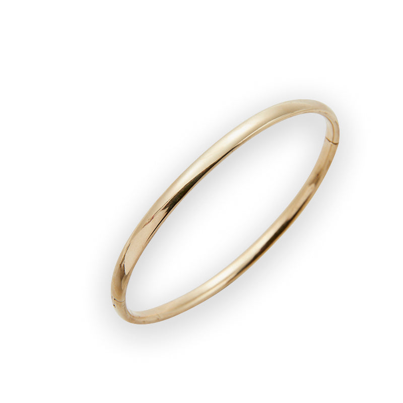 The classic gold bangle from Jeuje Fine Jewelry on a white background