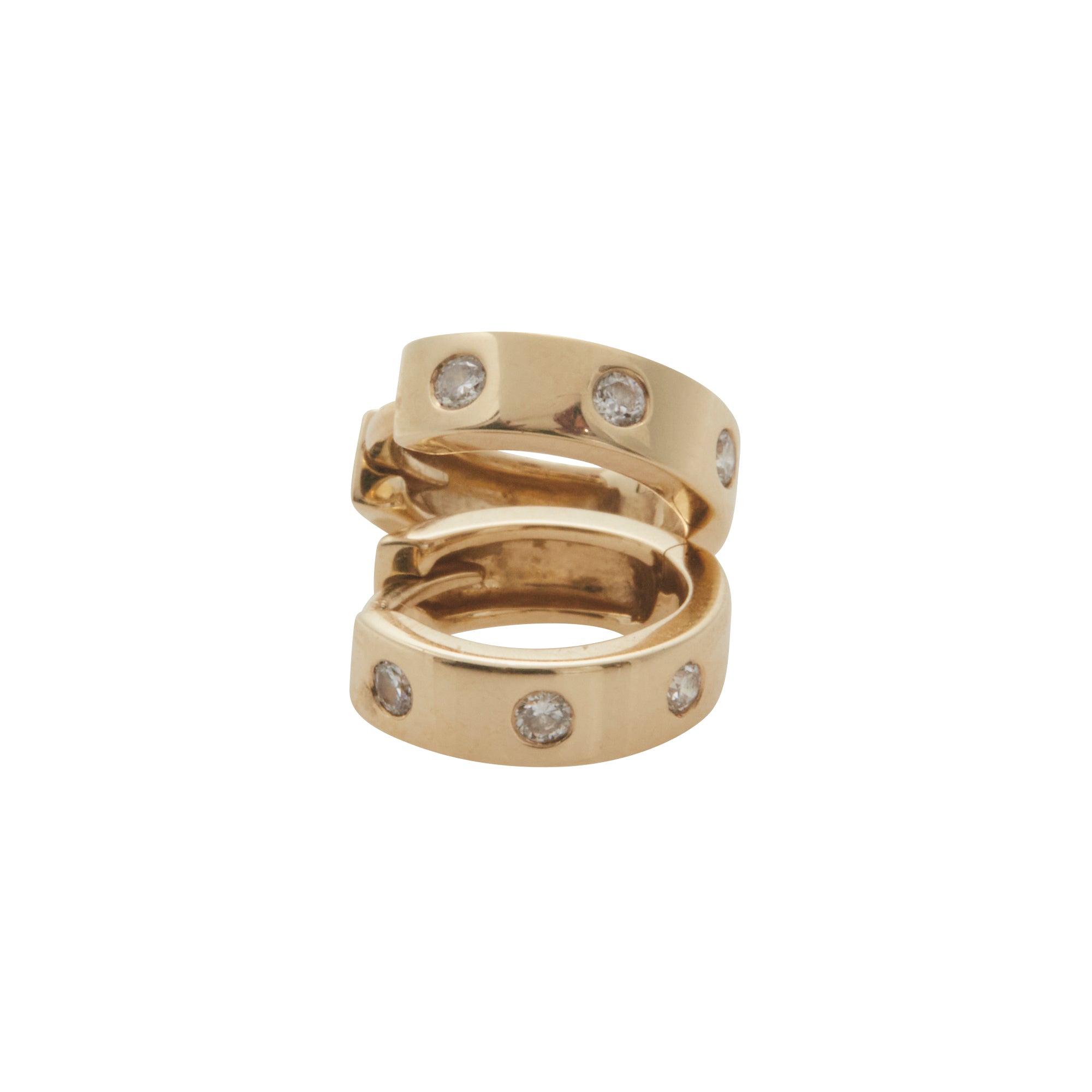 Yellow gold huggies containing 3 diamonds stacked on top of each other from Jeuje Jewelry on a white background