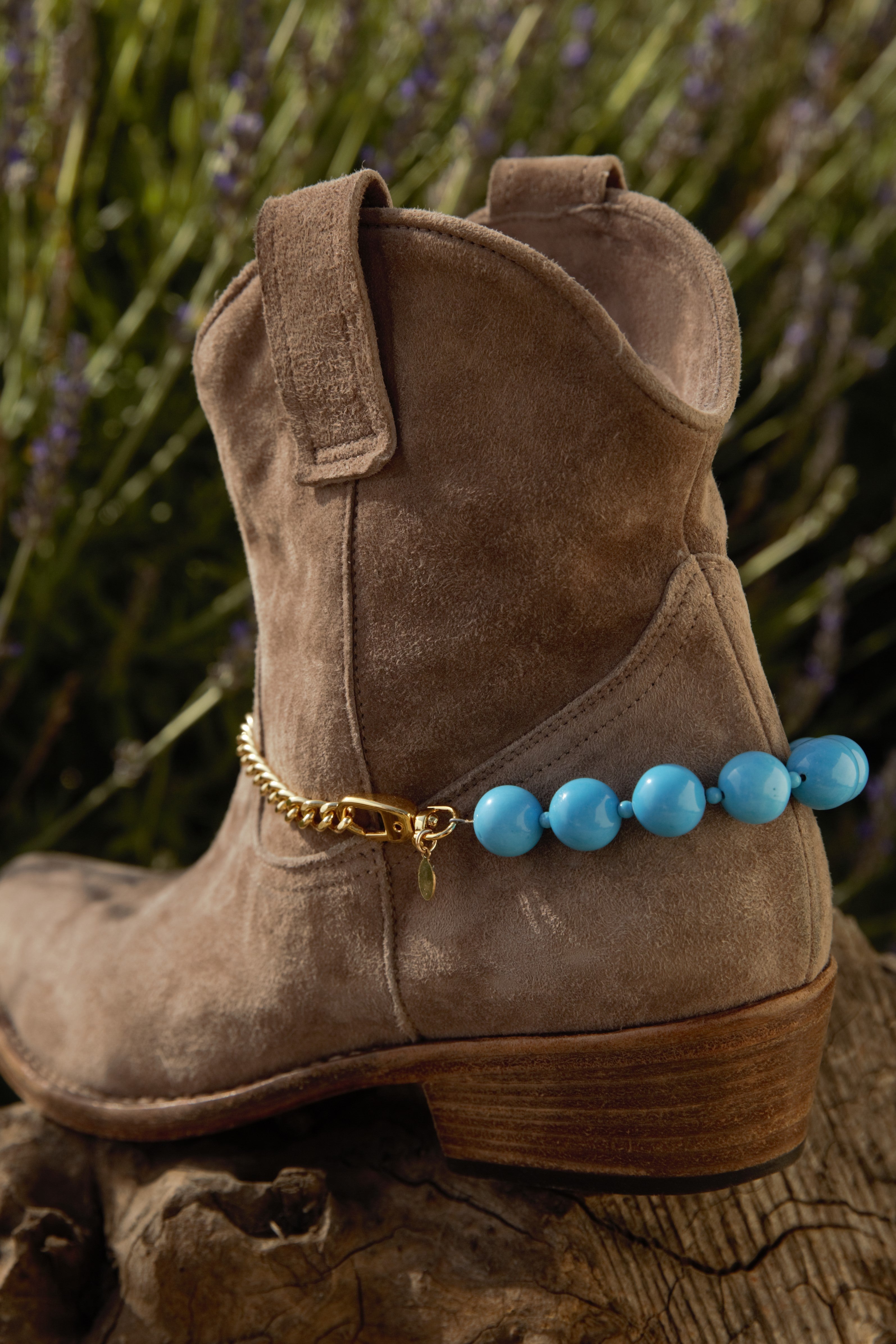 Buff cowboy boot with turquoise spur with brass chain