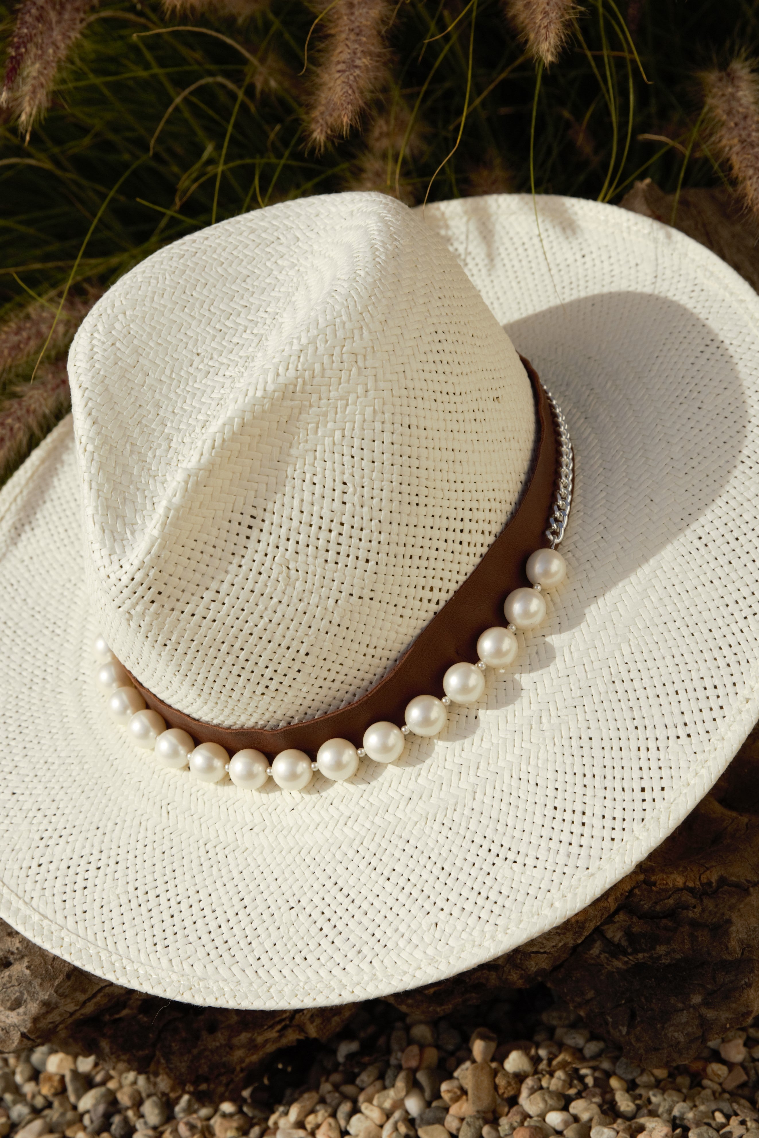 Straw hat featuring the white pearl hat band with steel chain